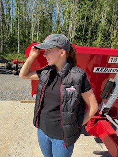 Girl wearing the Redrock Kids Black Gilet with Red Zip along with their vintage blue cap.